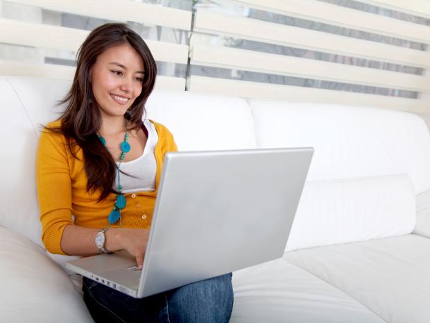 women using laptop on couch