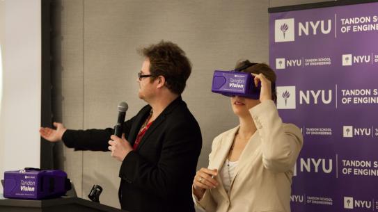 Alicia Glen, Deputy Mayor for Housing & Economic Development, tries on a VR headset while NYU Tandon faculty member Mark Skwarek demonstrates Tandon's VR application that travels to Mars.