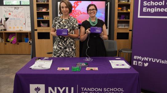Cindy Lewis, Assistant Director of Special Events at NYU Tandon Office of Enrollment Management, and Elizabeth Ensweiler, NYU Tandon Director of Enrollment Management, demonstrate Tandon's two virtual reality mobile applications. 