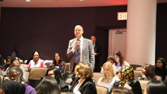 NYU President Andy Hamilton asking a question