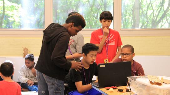 students coding at a laptop
