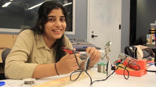 female student using electrical equipment