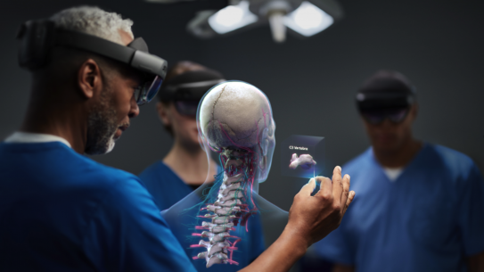 Doctors observing a 3D rendering of skeleton 