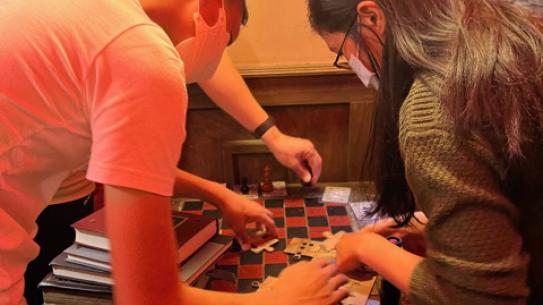 Team solving a jigsaw puzzle on a chess board