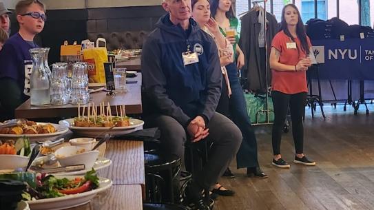 Seated Individuals Looking at Grads