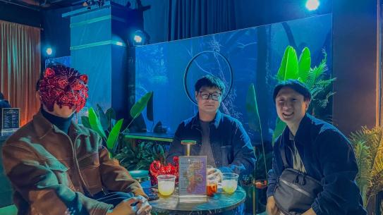 Students enjoying snacks and chatting at a decorated seating area.