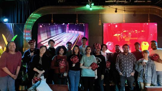 Group photo of PhD students and organizers at the Squid Game-themed event.