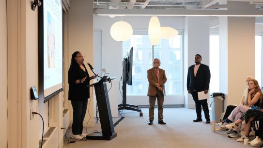 Three lecturers are giving a speech