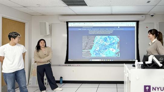 Pascale Ergas, U.P. Nguyen, and Zoe Tseng in front of a projected map of NYC.