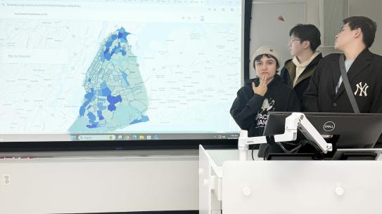 You Li, Keyang Yan, Lisette Gaxiola speaking in front of a map of NYC