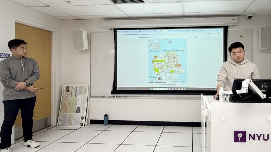 Yan Li and Kailun Li speaking in front of a map of San Francisco.