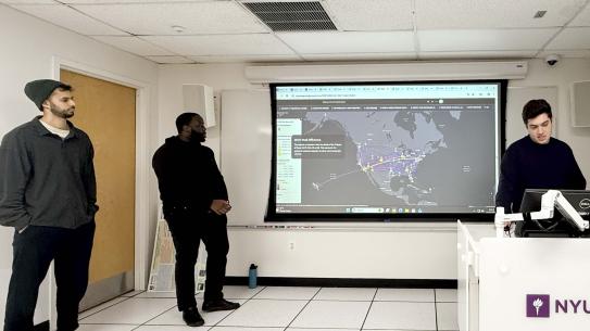 Nissim Ram, Michael Okoro, and Matt Ghadimi in front of a map of the US.