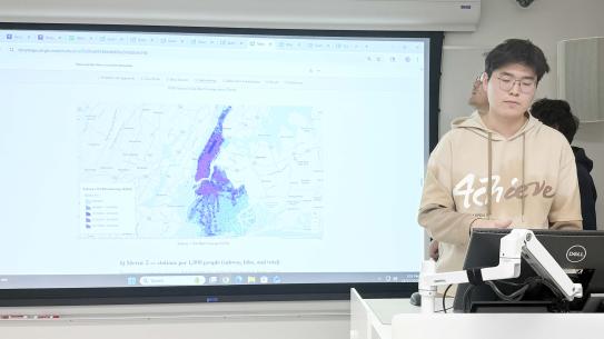 Jerry Zhao, Haozheng Liu, and Kaiwen Lin in front of a map of NYC.