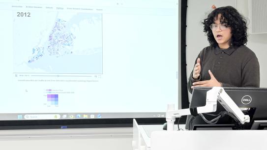 Manjiri Palayekar in front of a map of NYC