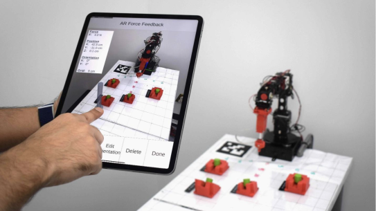User using touchscreen to control robot
