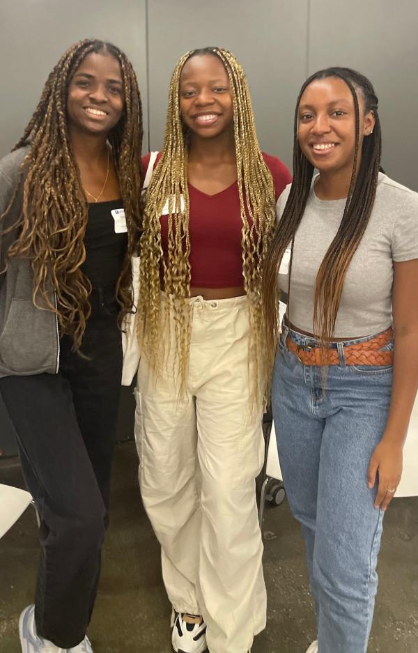 three smiling students at Students of Color Welcome