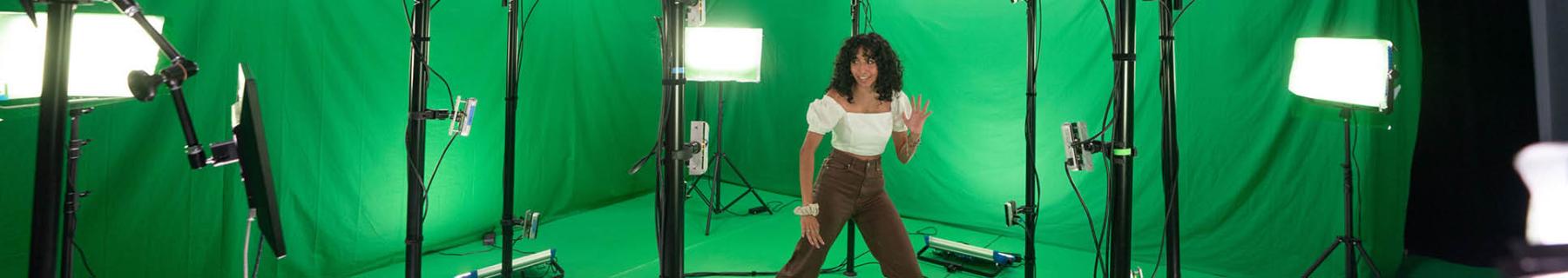 A student wearing a VR headset in motion capture studio