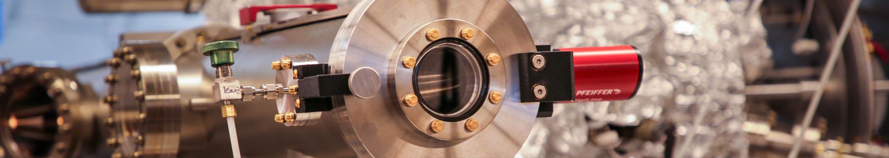 Close-up of stainless steel scientific vacuum chamber equipment in a laboratory setting