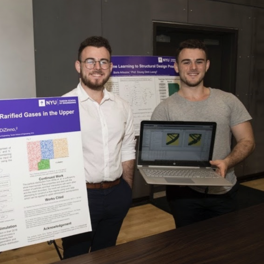 two brothers standing by research poster