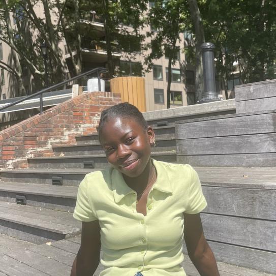Aminata Dioume using a yellow top