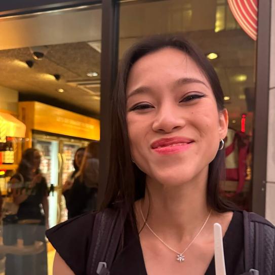 asian woman smiling and holding an ice cream