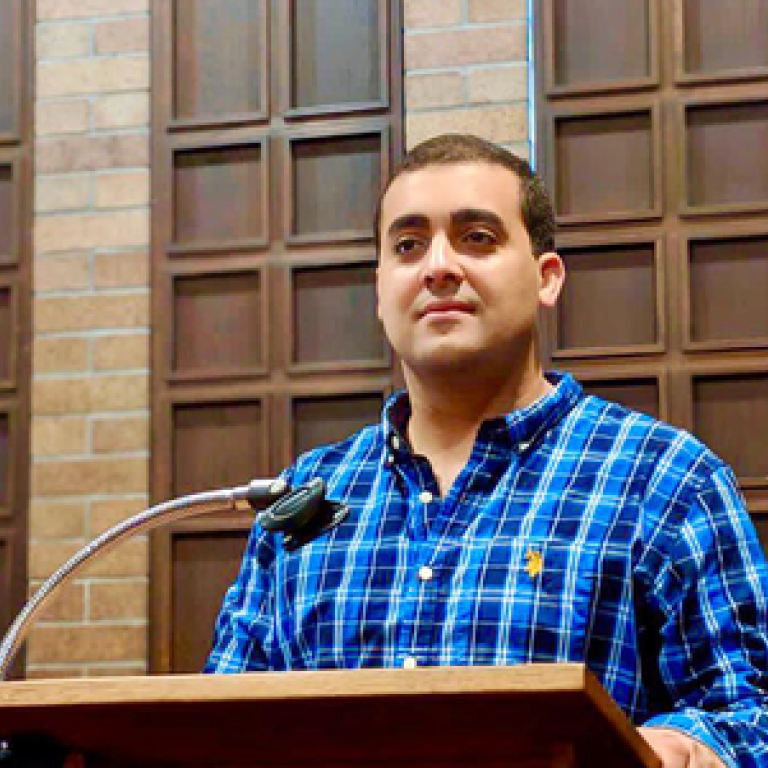 Amine Mohamed Aboussalah using a blue and dark blue checkered shirt