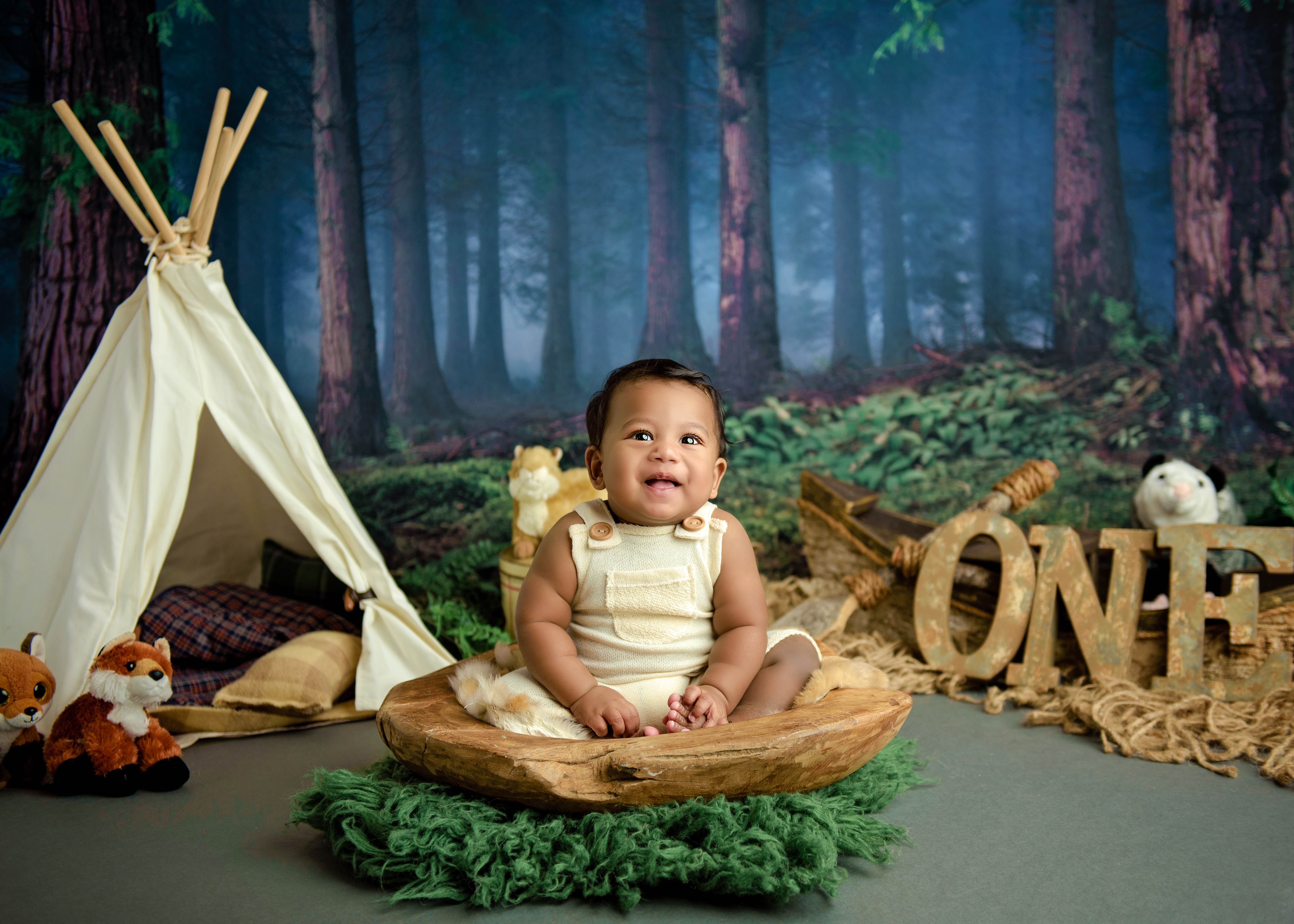 one year old baby in forest scene