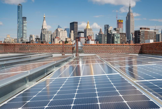 solar cells on roof with NYC skyline in background