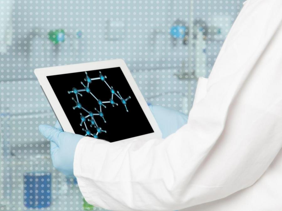 gloved hands holding ipad with molecular structure
