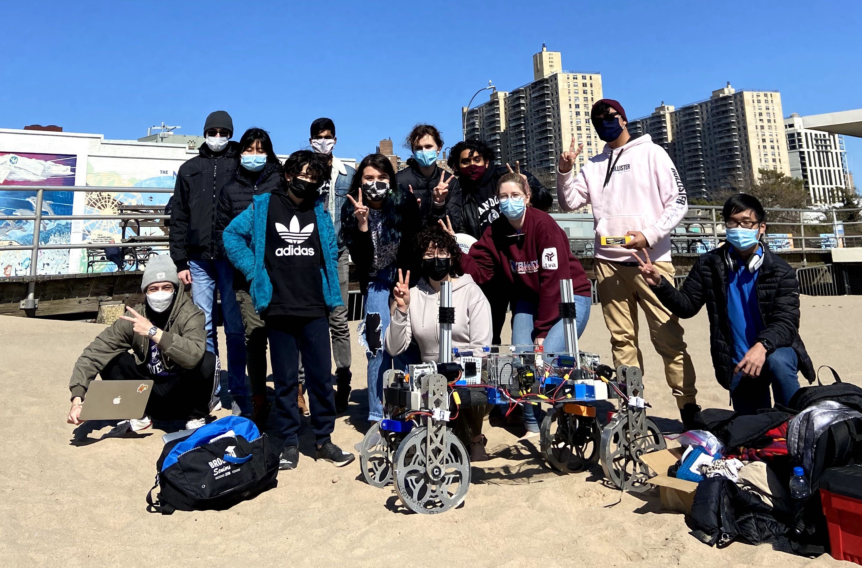 The robotics team on the beach with their Mars rover