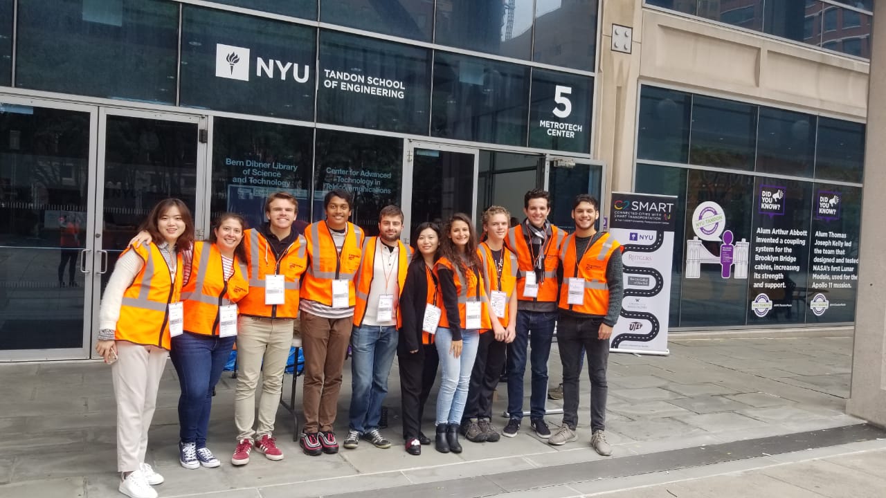 group of students wearing construction vests in front of Dibner building