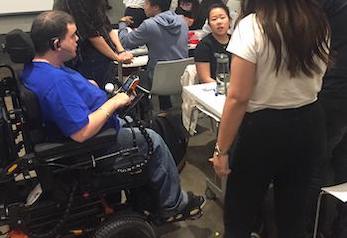 man in wheelchair with students
