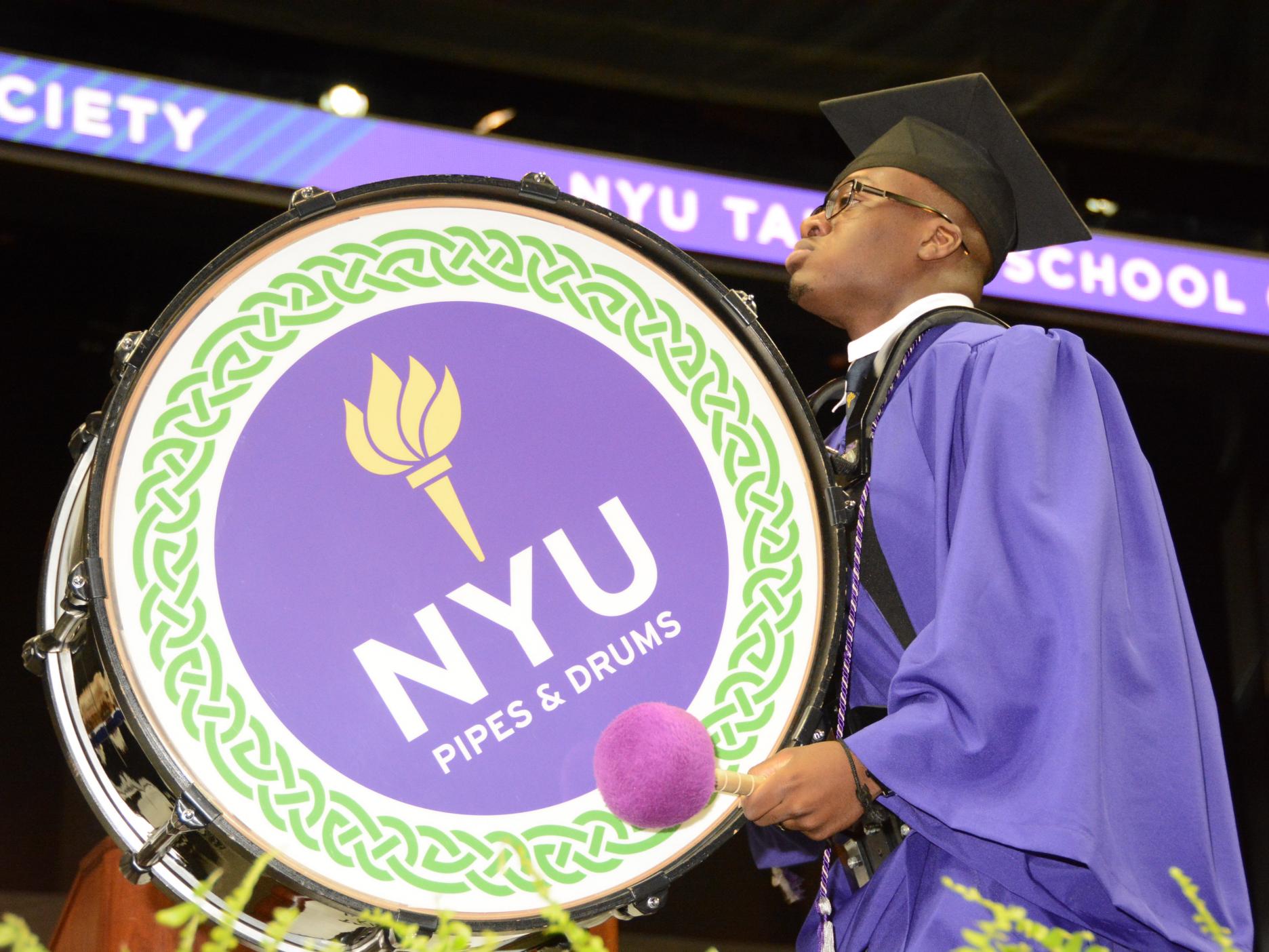 black student playing drum at graduation