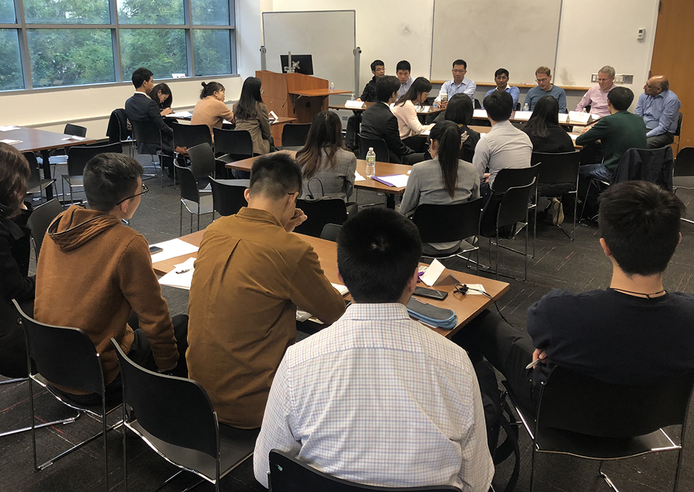 students in a classroom listening to a panel of speakers