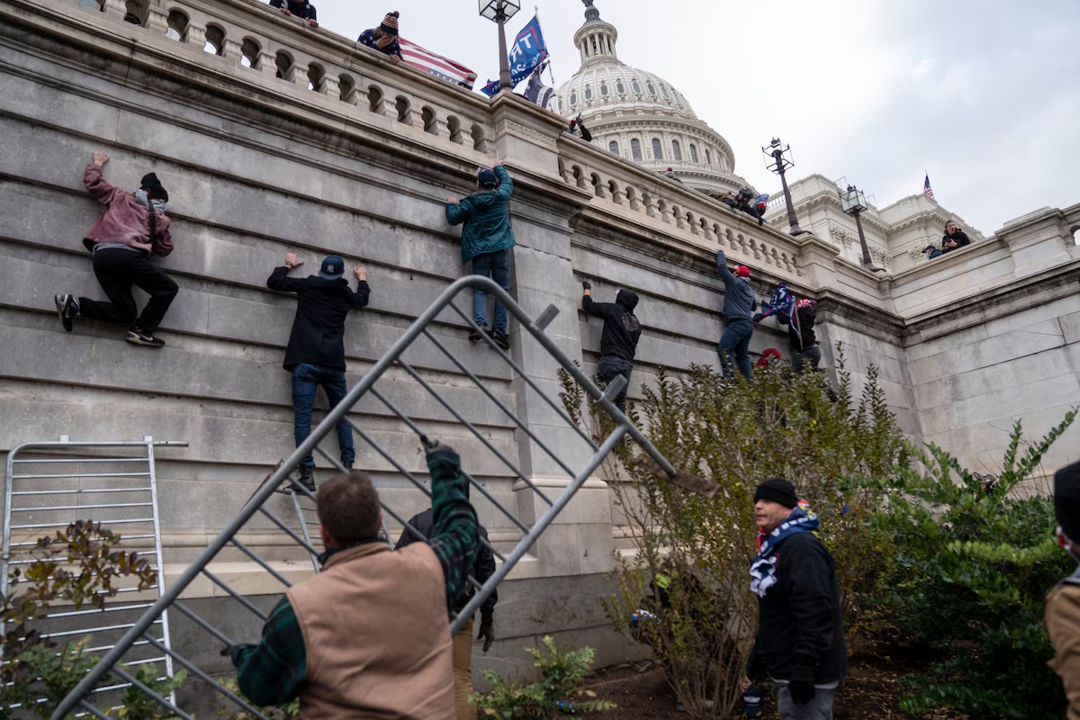 Trump supporters scaled the walls on the Senate side of the US Capitol and gained access inside the building during a massive protest in Washington, DC on January 6, 2021. (Michael Robinson Chavez/The Washington Post)