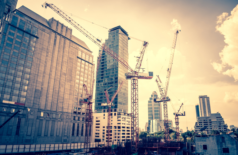 urban construction site with tall cranes